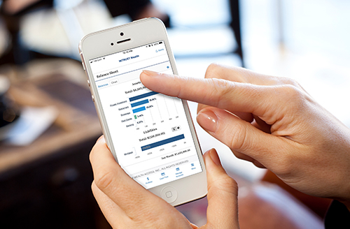 Hands holding an iPhone displaying WinThrust Wealth Access