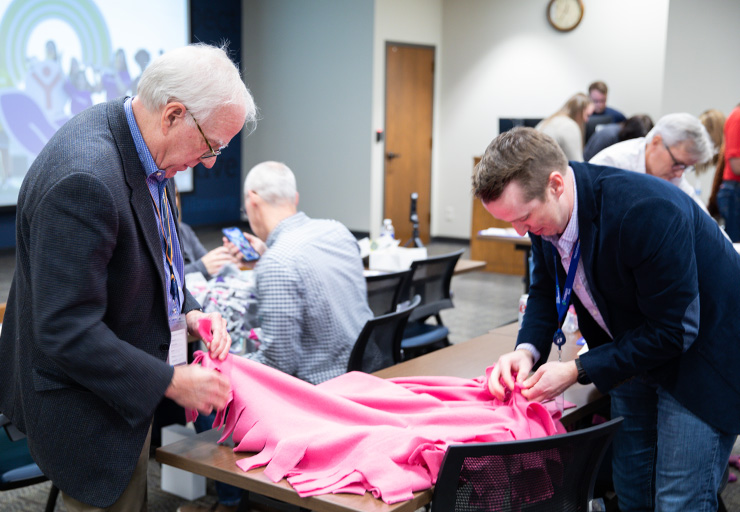Employees participating in a United Way blanket-making event